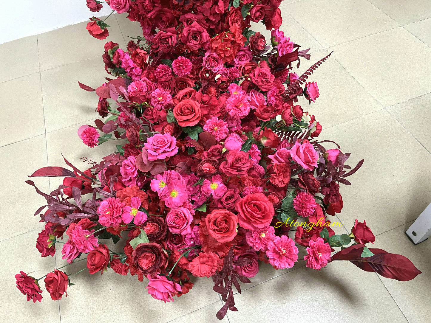 close up artificial wedding arch flower garland pink red