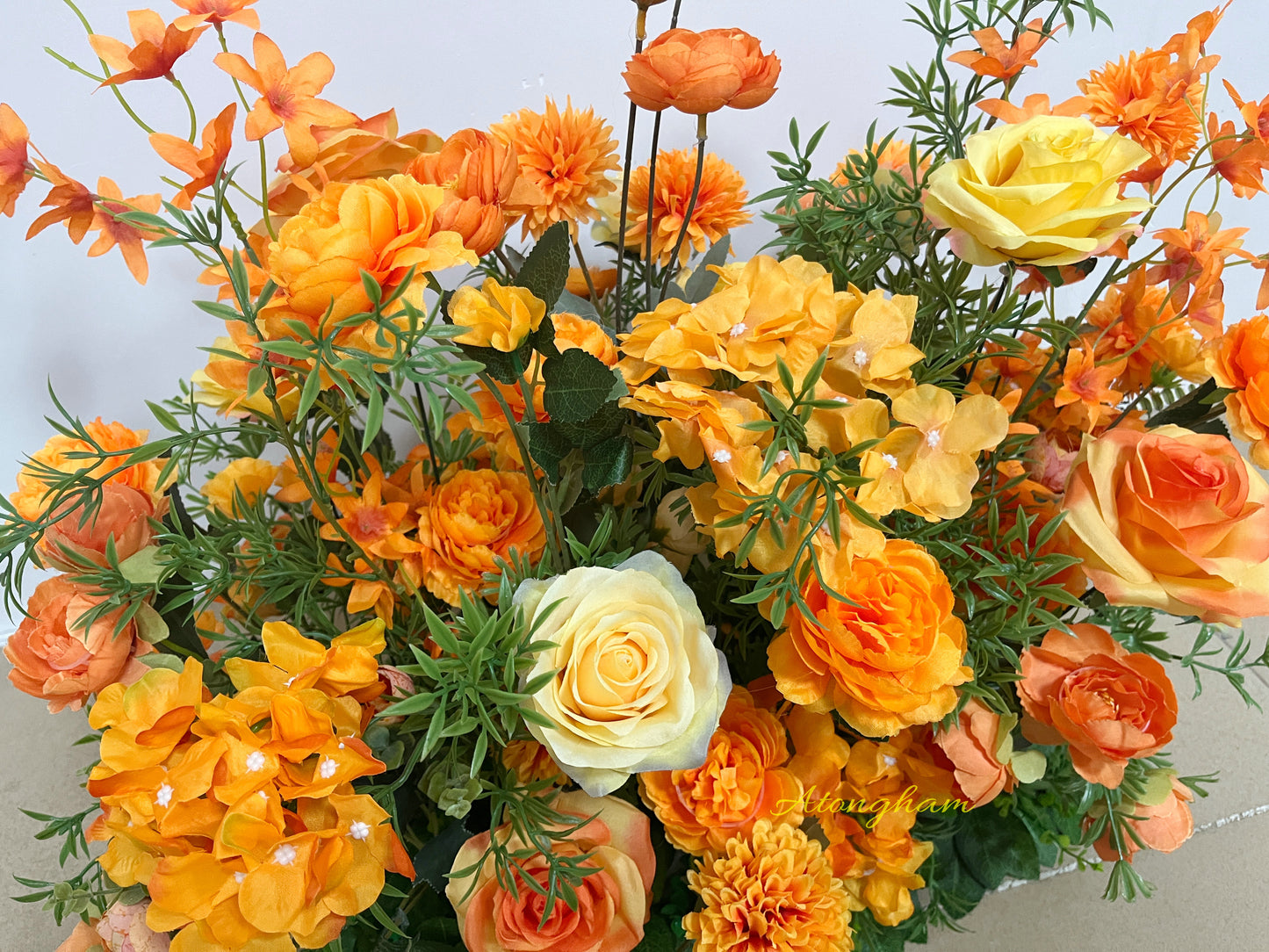 orange artificial flowers for outdoor ceremony aisle